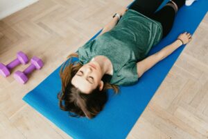 Woman laying on mat doing pilates